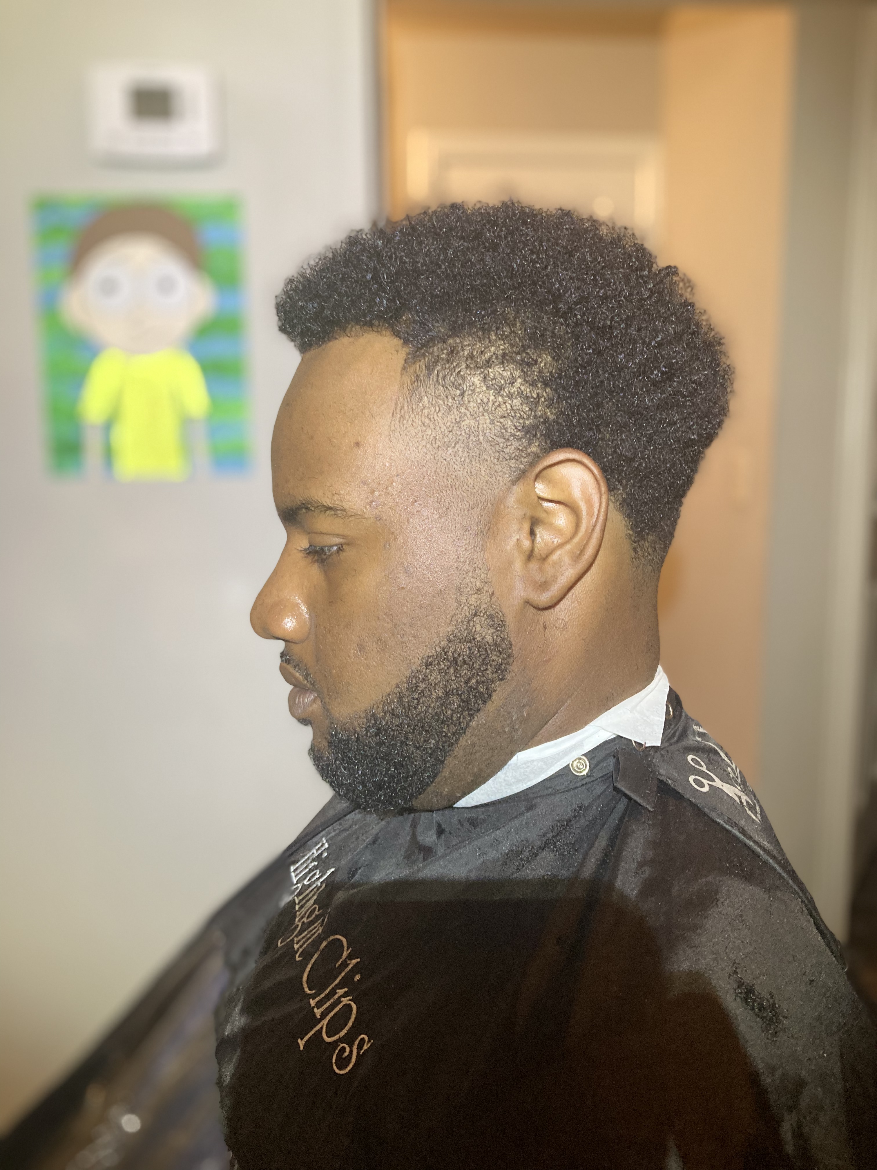 Fade with textured curls and full beard