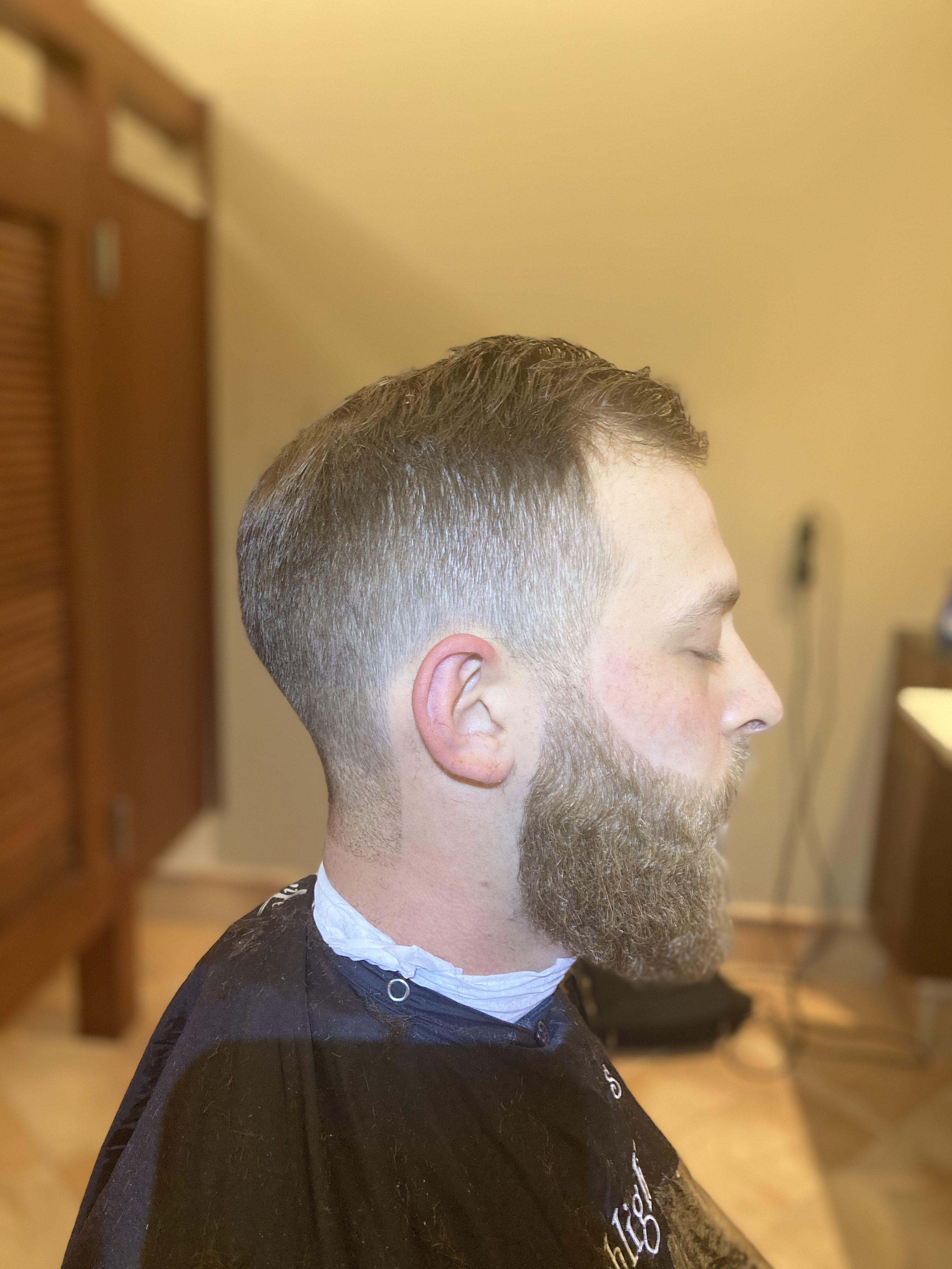 Mid-skin fade with full brown beard